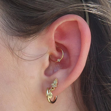 close up of an ear with a daith and earlobe piercing done at the IRIS Boulder Colorado shop
