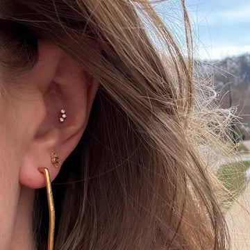 close up of two earlobe piercings done by the IRIS piercing shop in Boulder Colorado