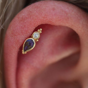 round cut and pear cut gemstones on a gold earring for a helix piercing done at IRIS Studios SLC shop