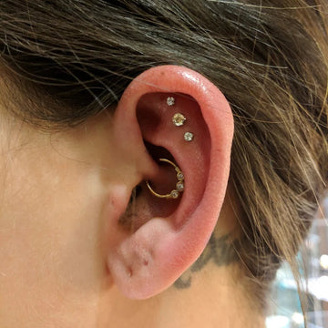 trio of cartilage piercings with a daith ear piercing done at the IRIS Boulder Colorado studio shop