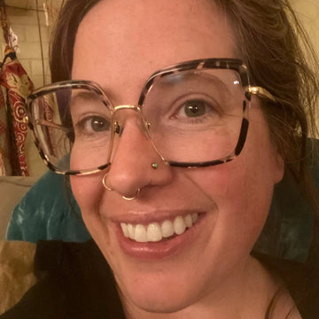 person with two nostril piercings and one septum nose piercing taken at the IRIS Boulder Colorado shop