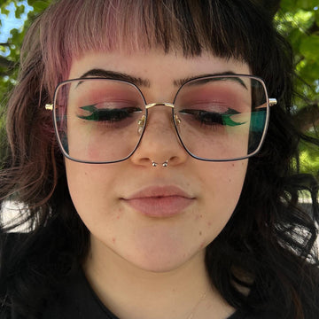 woman wearing glasses with a septum piercing she got from IRIS studio in Salt Lake City Utah