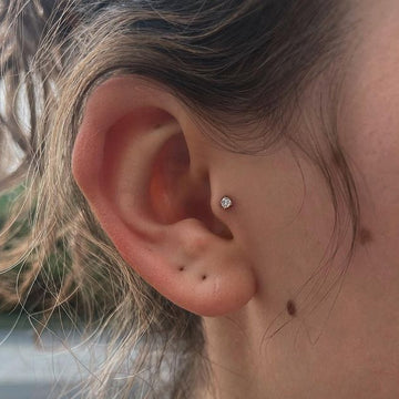 tragus ear piercing with a round diamond earring